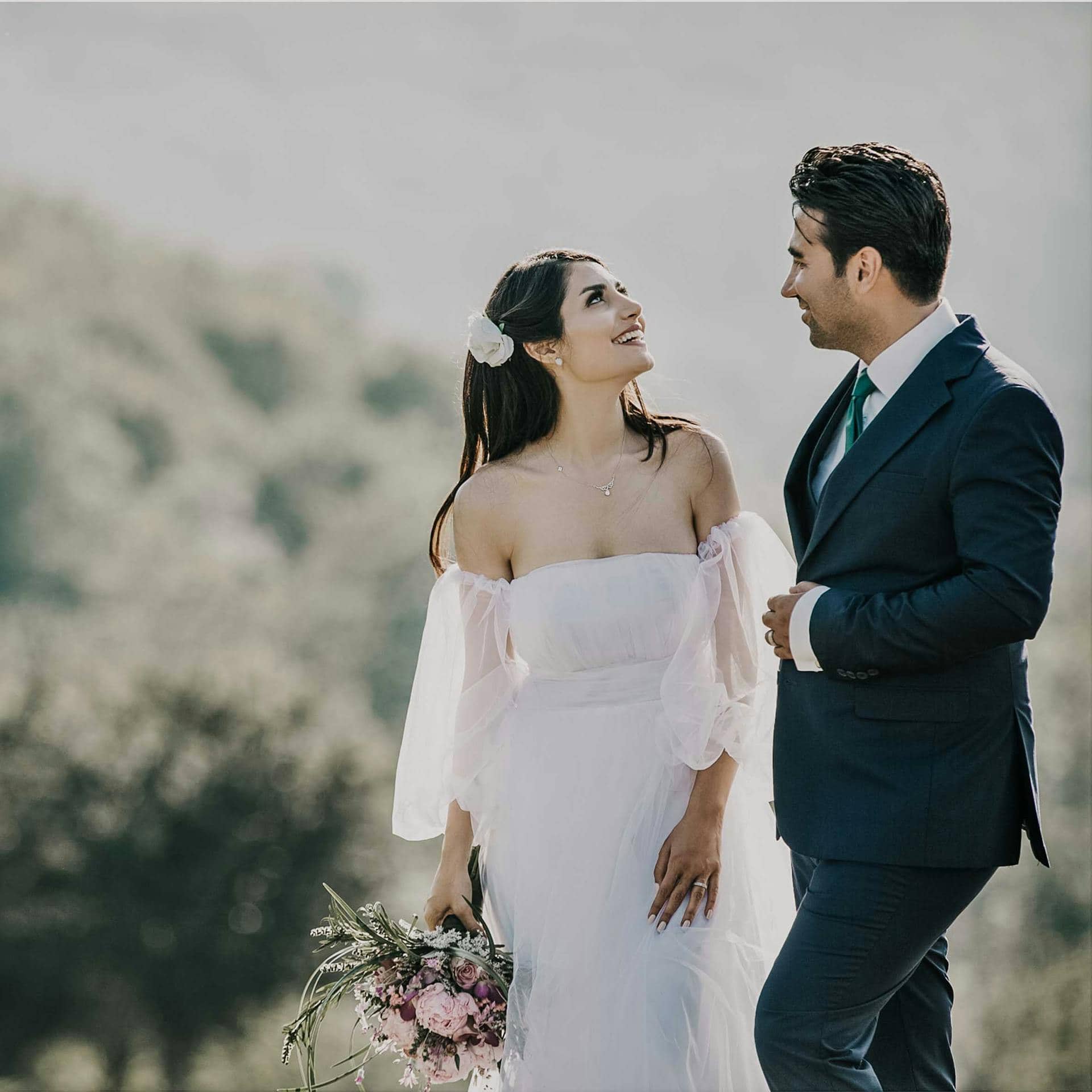 A couple photographed outdoors